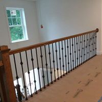 Home contractors remodeling railing on second floor